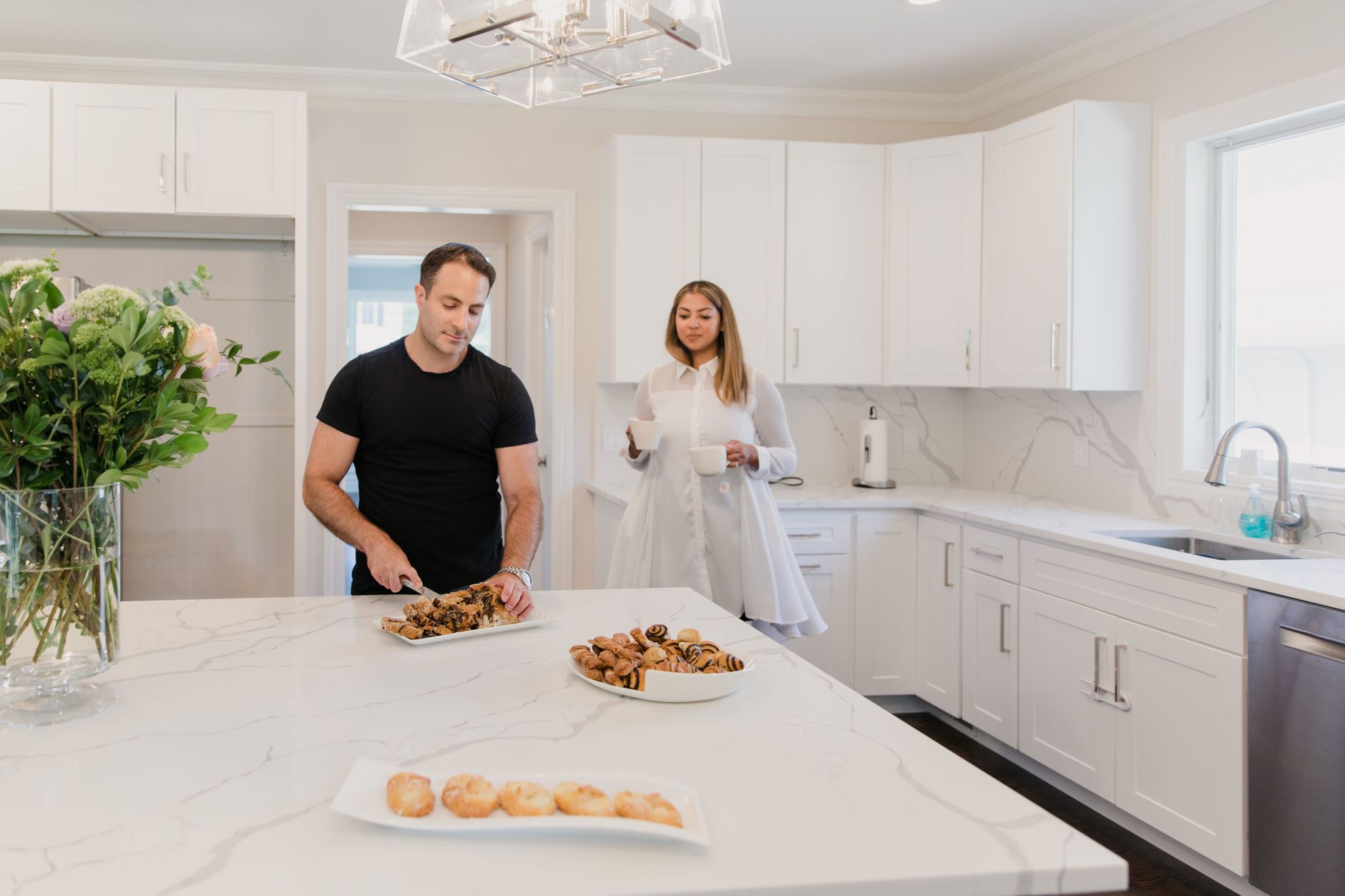 A couple enjoying pastries in a elegant kitchen setting